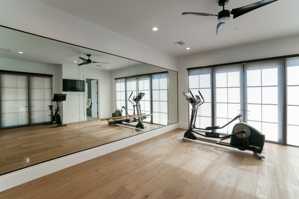 This is an example of a large contemporary multipurpose gym in Phoenix with white walls, light hardwood floors and beige floor.
