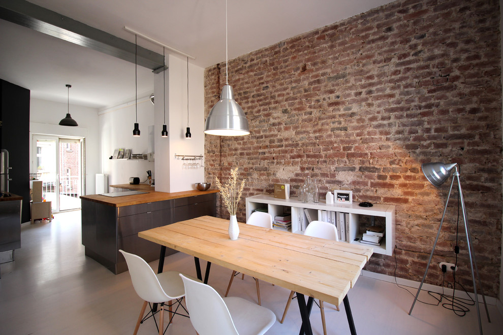Photo of an industrial open plan dining in Cologne with light hardwood floors.