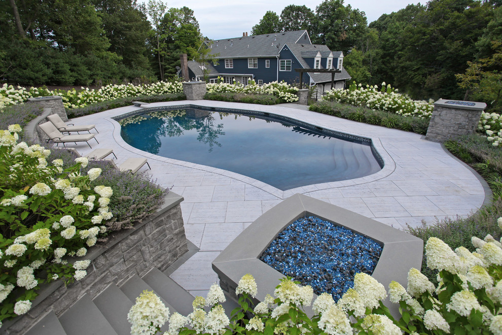 Large contemporary side yard custom-shaped lap pool in New York with tile.