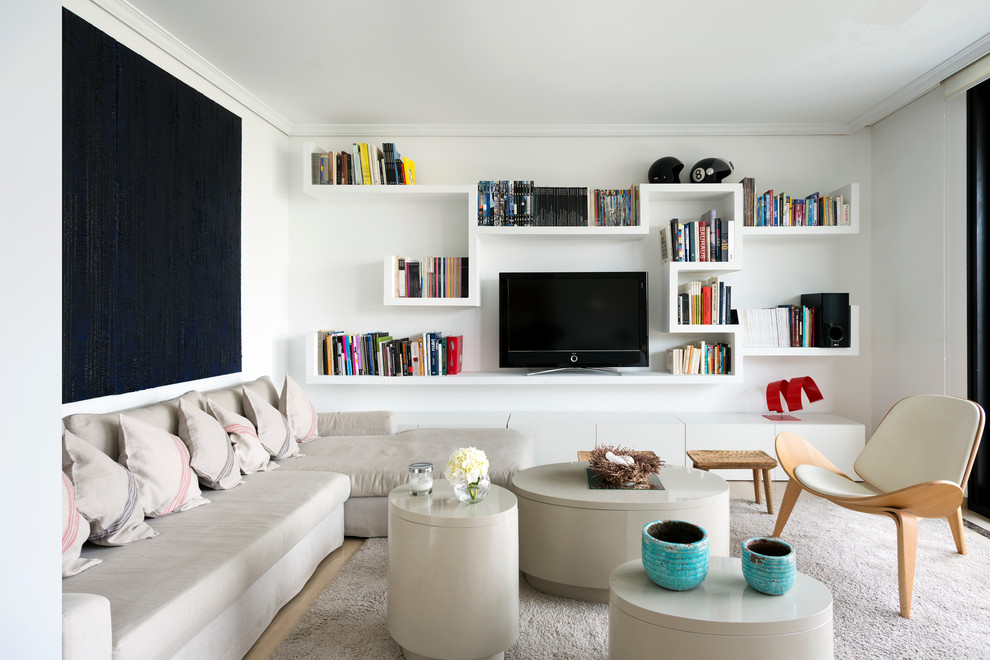 Design ideas for a small contemporary open concept family room in Madrid with white walls, a freestanding tv, a library, no fireplace and carpet.