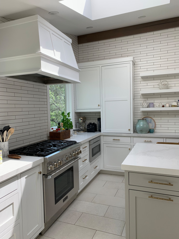 Inspiration for a large transitional u-shaped eat-in kitchen in San Francisco with a farmhouse sink, shaker cabinets, white cabinets, quartz benchtops, white splashback, subway tile splashback, panelled appliances, ceramic floors, with island, grey floor, white benchtop and vaulted.