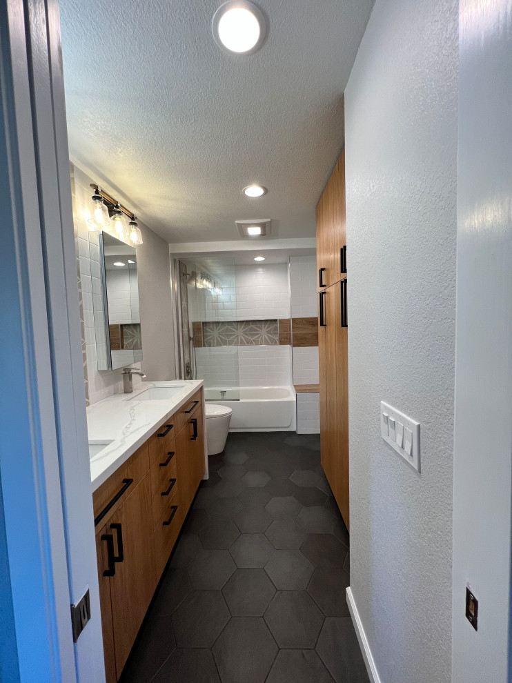 Mid-sized trendy white tile and ceramic tile ceramic tile, black floor and double-sink bathroom photo in San Diego with flat-panel cabinets, medium tone wood cabinets, an undermount sink, quartz countertops, a hinged shower door, white countertops and a built-in vanity
