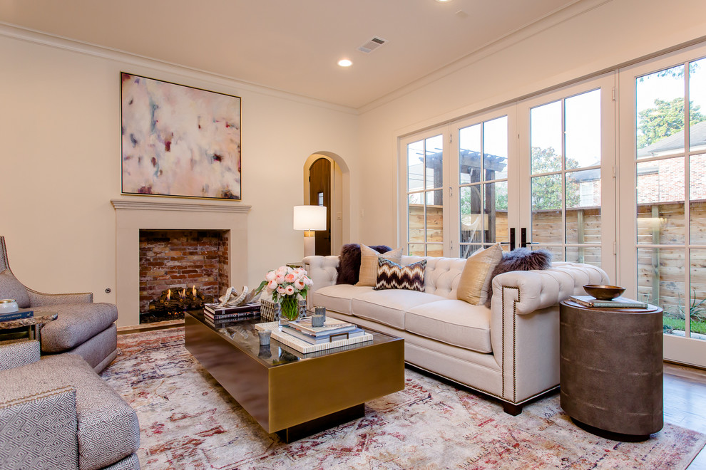 Photo of a mid-sized transitional open concept family room in Houston with beige walls, dark hardwood floors, a standard fireplace and a wall-mounted tv.