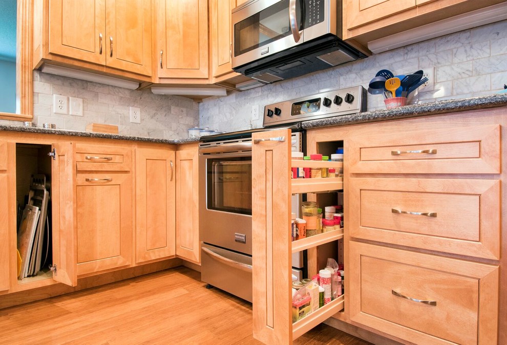 Inspiration for a mid-sized transitional u-shaped bamboo floor and brown floor enclosed kitchen remodel in Cincinnati with a double-bowl sink, shaker cabinets, light wood cabinets, granite countertops, gray backsplash, marble backsplash, stainless steel appliances, a peninsula and gray countertops