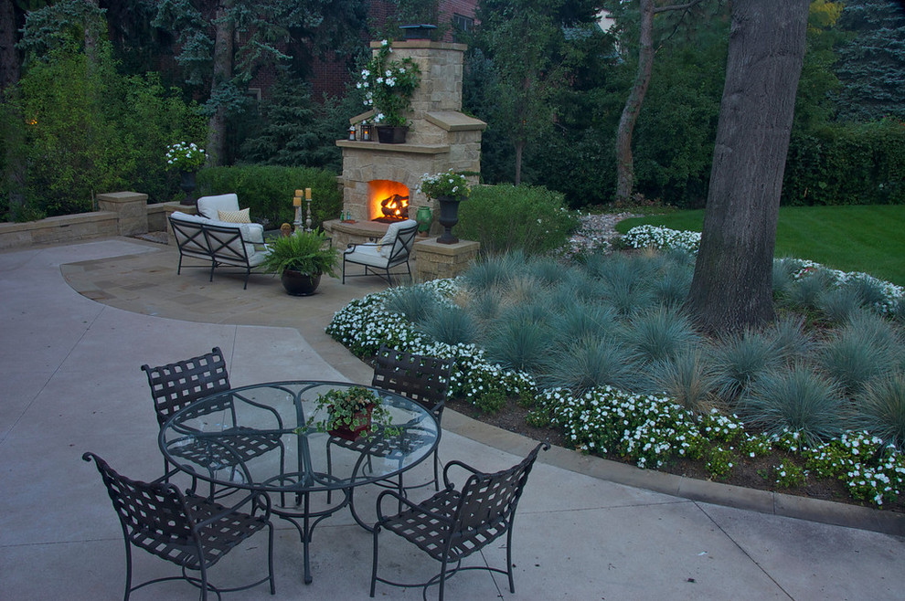 Inspiration for a mid-sized traditional backyard patio in Denver with a fire feature, tile and no cover.