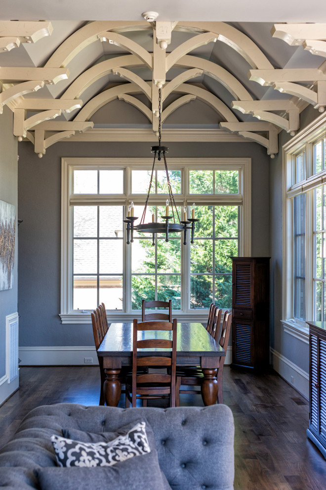 Inspiration for a large dining room in Raleigh with grey walls, dark hardwood floors, brown floor and exposed beam.