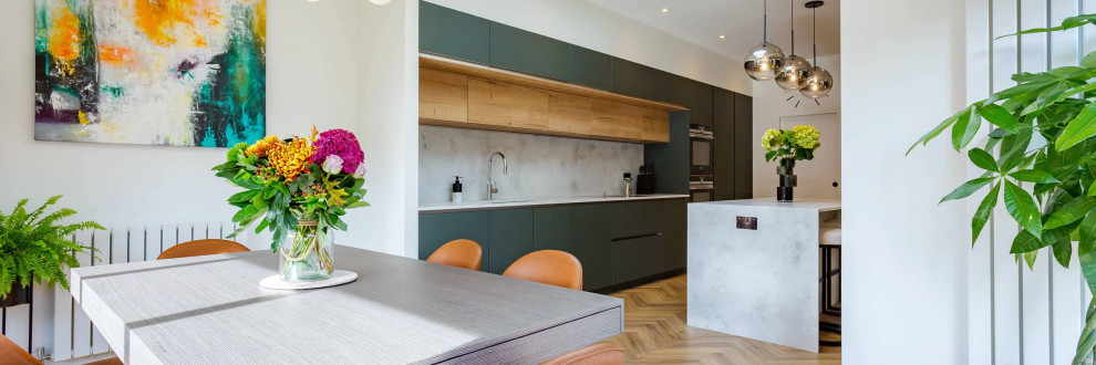 This is an example of a large modern single-wall kitchen/diner in Hertfordshire with flat-panel cabinets, grey cabinets, quartz worktops, an island and grey worktops.