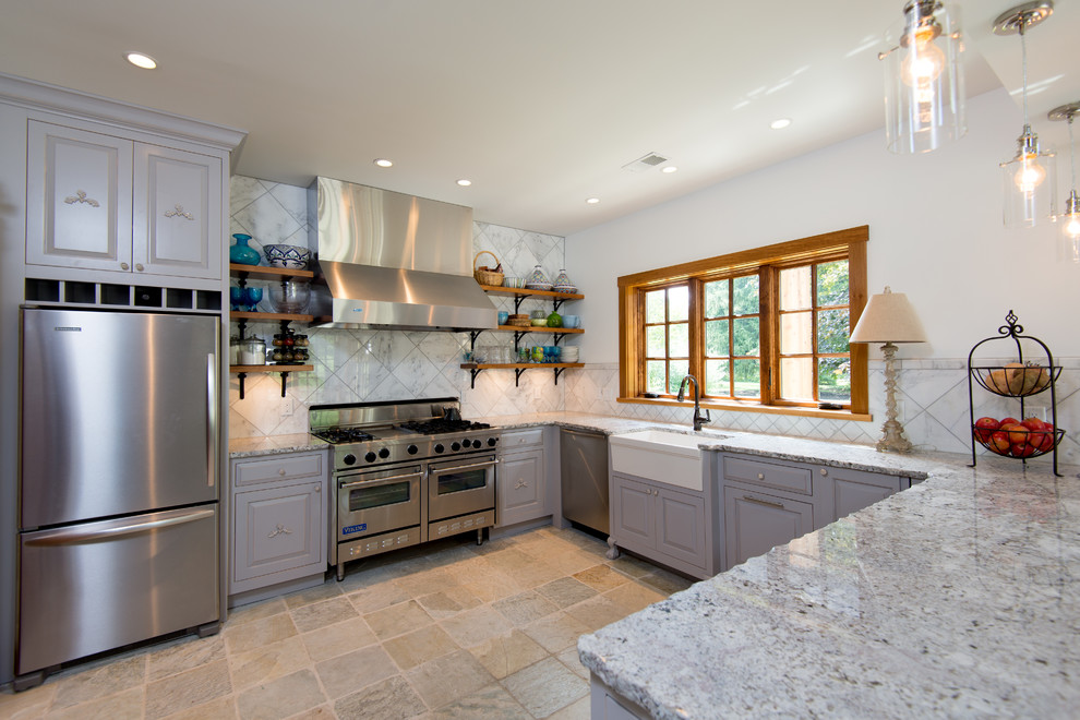 Inspiration for a large transitional u-shaped separate kitchen in Cincinnati with a farmhouse sink, raised-panel cabinets, stainless steel appliances, granite benchtops, white splashback, marble splashback, limestone floors, a peninsula, beige floor, grey cabinets and multi-coloured benchtop.
