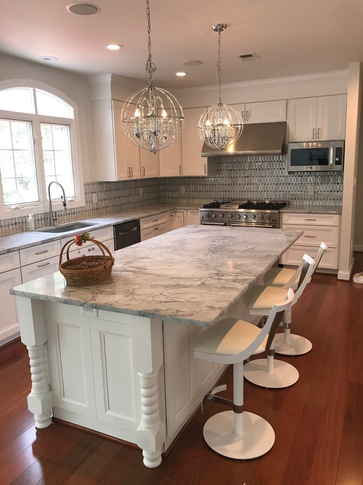 Design ideas for a mid-sized traditional l-shaped kitchen in DC Metro with an undermount sink, recessed-panel cabinets, white cabinets, granite benchtops, grey splashback, stainless steel appliances, dark hardwood floors, with island, red floor and grey benchtop.