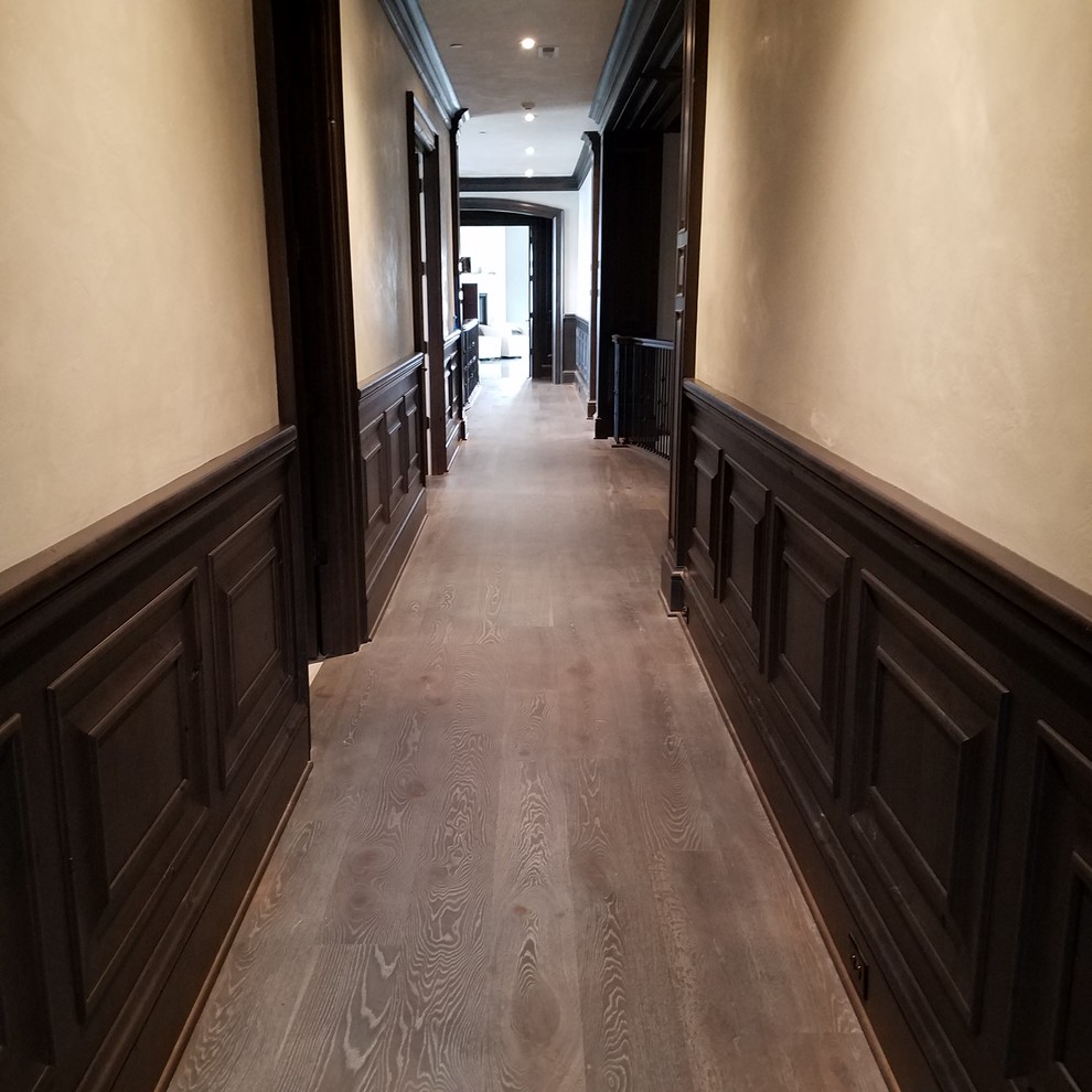 Small transitional hallway in Portland with white walls, dark hardwood floors and black floor.