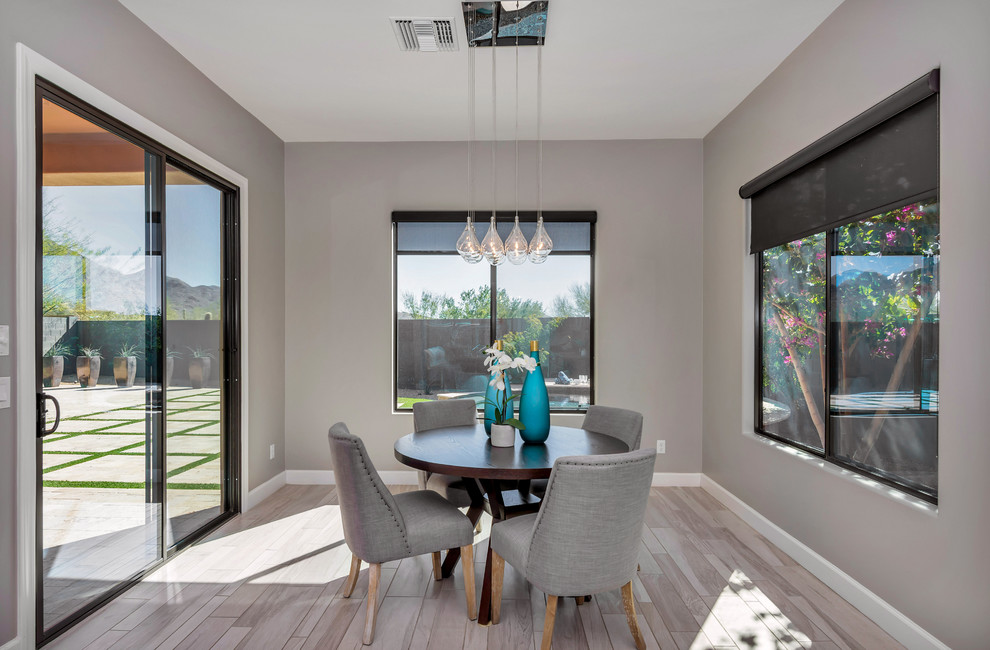 Kitchen/dining room combo - mid-sized transitional ceramic tile and gray floor kitchen/dining room combo idea in Phoenix with gray walls and no fireplace