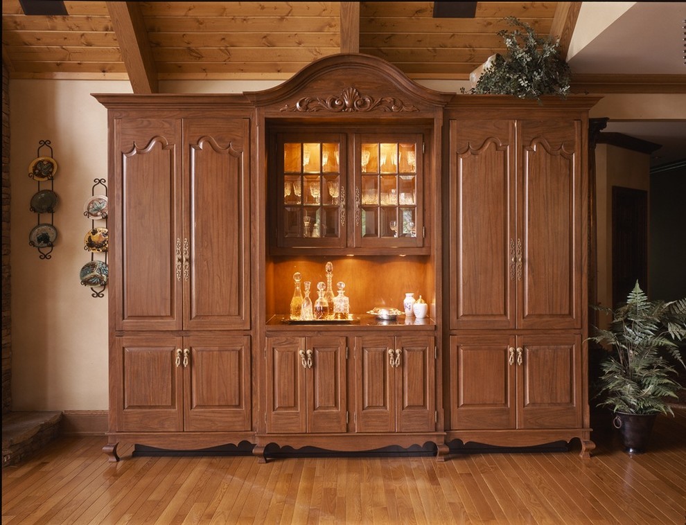 Photo of a large traditional single-wall wet bar in Charlotte with light wood cabinets and wood benchtops.