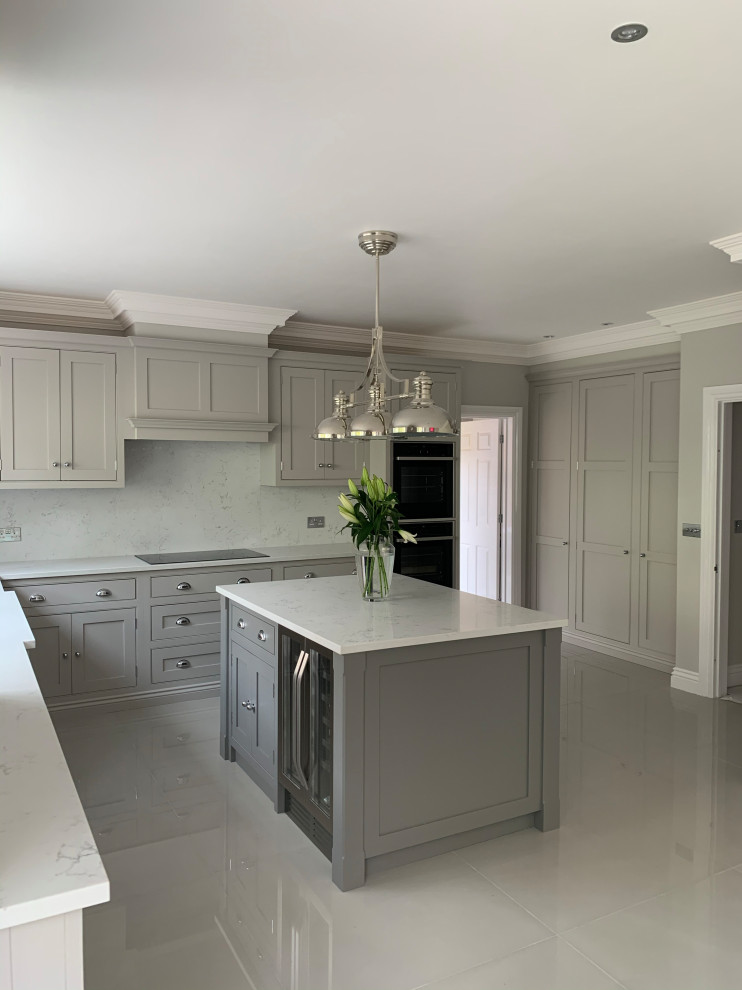 Example of a mid-sized classic u-shaped enclosed kitchen design in Surrey with beaded inset cabinets, quartzite countertops, an island and white countertops