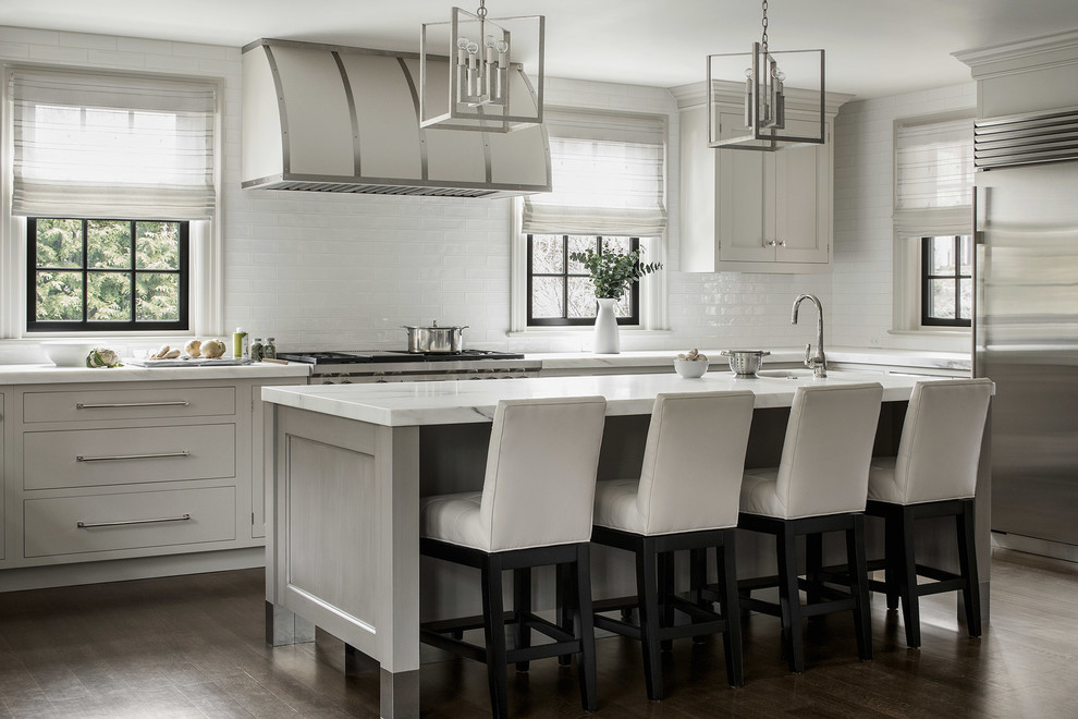 Inspiration for a mid-sized transitional l-shaped kitchen in New York with an undermount sink, grey cabinets, marble benchtops, white splashback, porcelain splashback, stainless steel appliances, dark hardwood floors, with island and brown floor.