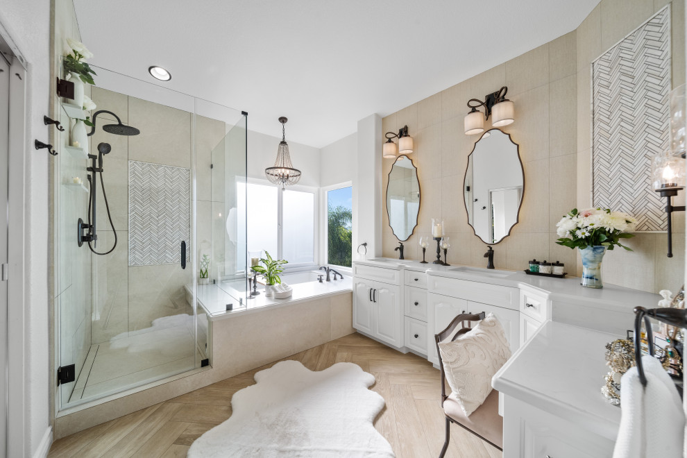 Photo of a large traditional ensuite bathroom in San Diego with raised-panel cabinets, white cabinets, a submerged bath, a corner shower, a two-piece toilet, beige tiles, porcelain tiles, grey walls, wood-effect flooring, a submerged sink, engineered stone worktops, beige floors, a hinged door, grey worktops, a shower bench, double sinks, a built in vanity unit and a vaulted ceiling.