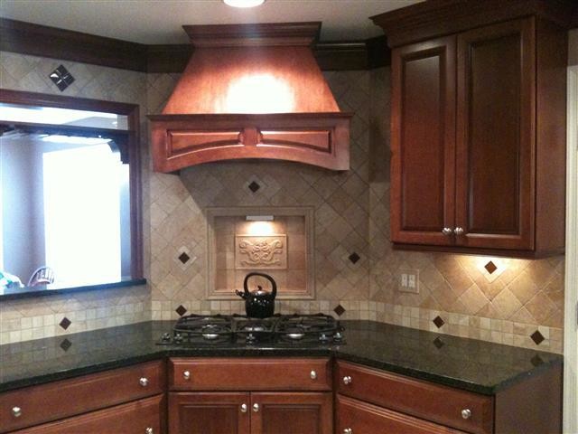 Kitchen photo in DC Metro with beaded inset cabinets, medium tone wood cabinets and beige backsplash