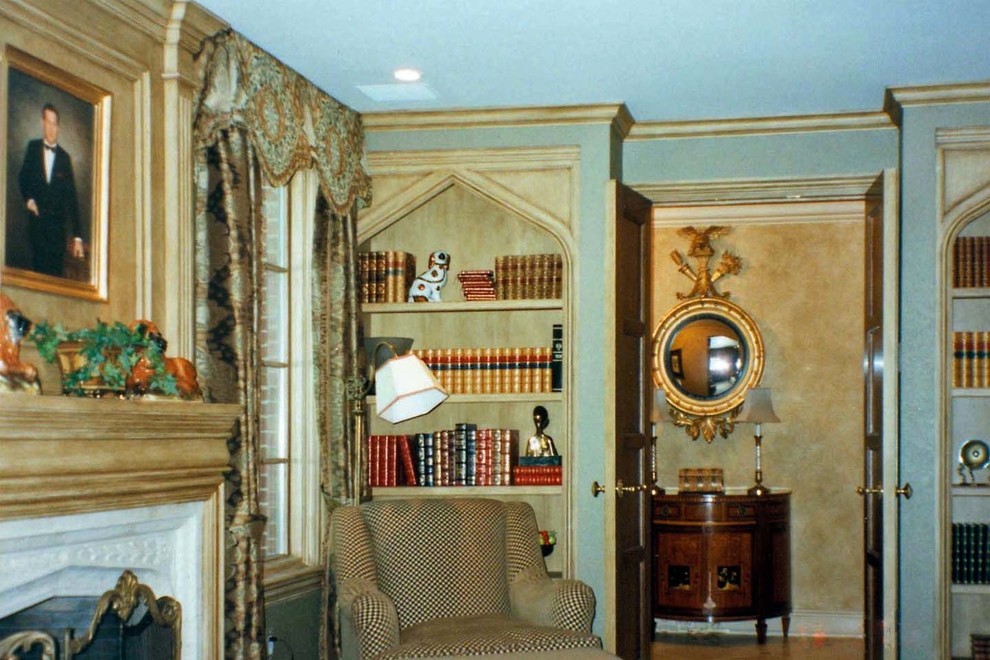 Inspiration for a large traditional home office in Boston with a library, green walls, carpet, a standard fireplace, a stone fireplace surround and green floor.