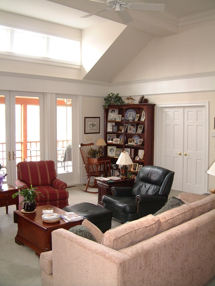 This is an example of a mid-sized traditional open concept family room in Other with pink walls, carpet and a library.