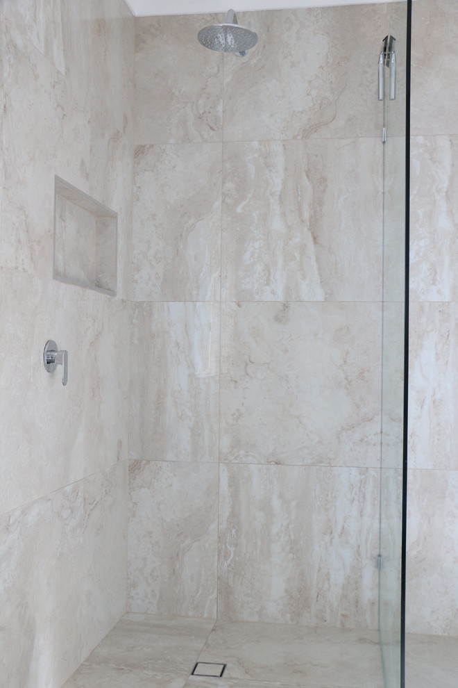 Large contemporary 3/4 bathroom in Brisbane with an open shower, beige tile, porcelain tile, beige walls, porcelain floors, a vessel sink, solid surface benchtops, beige floor, a hinged shower door and white benchtops.