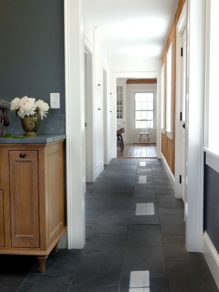 This is an example of a mid-sized traditional hallway in New York with slate floors, white walls and grey floor.