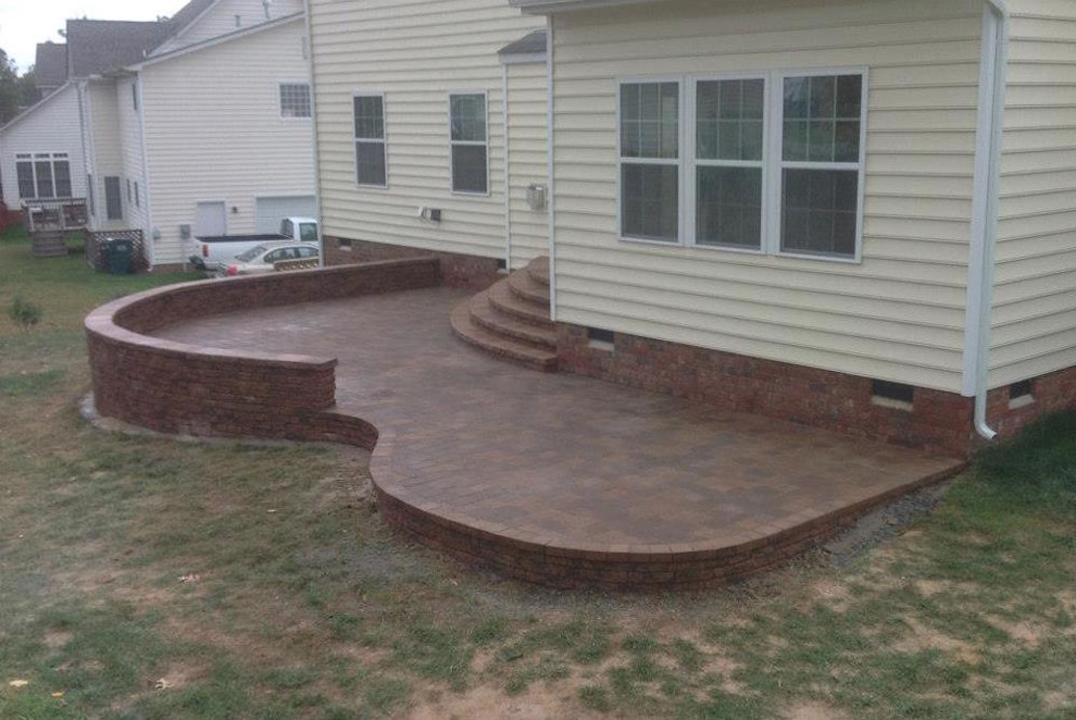 Photo of a mid-sized traditional backyard patio in Richmond with brick pavers and no cover.