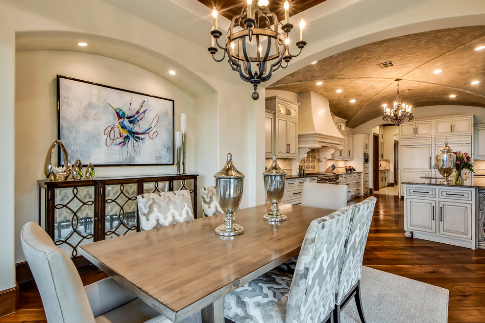 Inspiration for an expansive mediterranean kitchen/dining combo in Austin with white walls, no fireplace and dark hardwood floors.