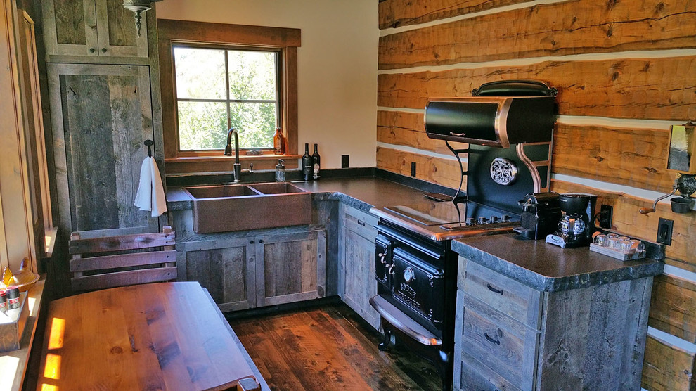 Small country l-shaped eat-in kitchen in Other with a farmhouse sink, shaker cabinets, distressed cabinets, granite benchtops, black appliances, dark hardwood floors and no island.