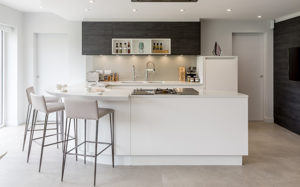 Design ideas for a mid-sized contemporary u-shaped kitchen in Berkshire with white cabinets, a peninsula, a double-bowl sink, open cabinets, grey splashback, glass sheet splashback, concrete floors and grey floor.