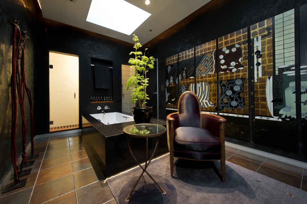 Photo of an asian bathroom in Los Angeles with a drop-in tub, an alcove shower, black walls and slate floors.
