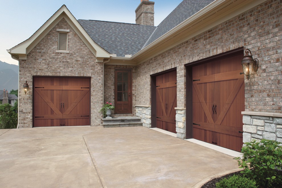 Photo of a traditional attached three-car garage in Philadelphia.