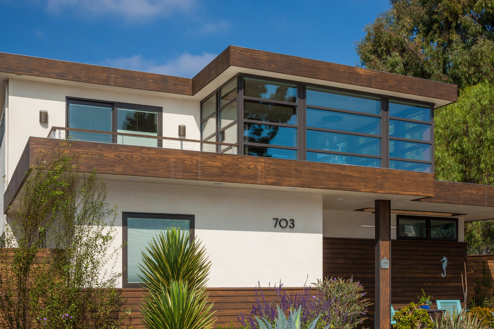 Large and beige contemporary two floor house exterior in Orange County with wood cladding.