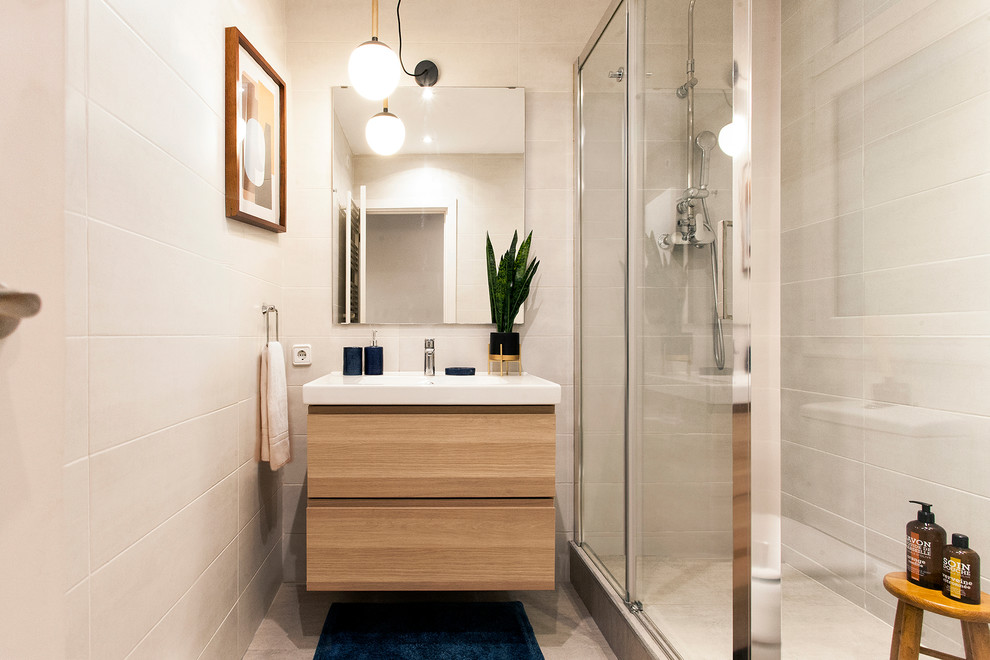 Example of a trendy white tile bathroom design in Barcelona with medium tone wood cabinets and white countertops