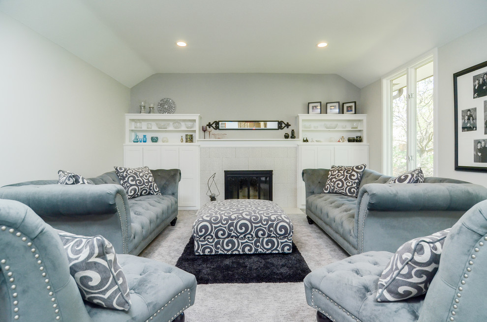 This is an example of a mid-sized transitional formal enclosed living room in Minneapolis with grey walls, carpet, a standard fireplace, a tile fireplace surround, no tv and grey floor.