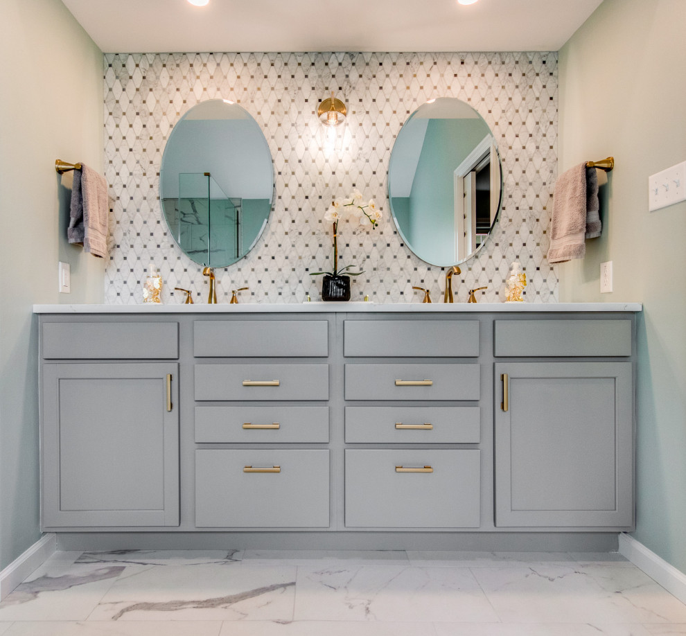 Design ideas for a medium sized traditional ensuite bathroom in St Louis with shaker cabinets, grey cabinets, a freestanding bath, a corner shower, white tiles, marble tiles, engineered stone worktops, white worktops, double sinks and a built in vanity unit.