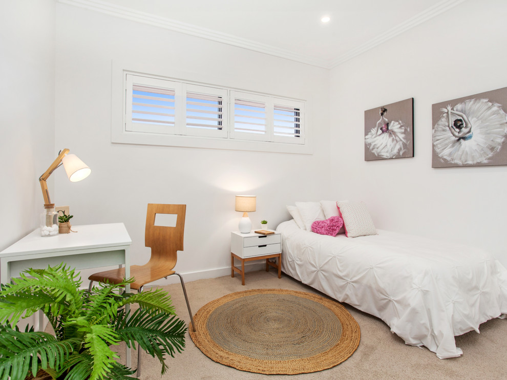 Mid-sized contemporary guest bedroom in Sydney with white walls, carpet and beige floor.