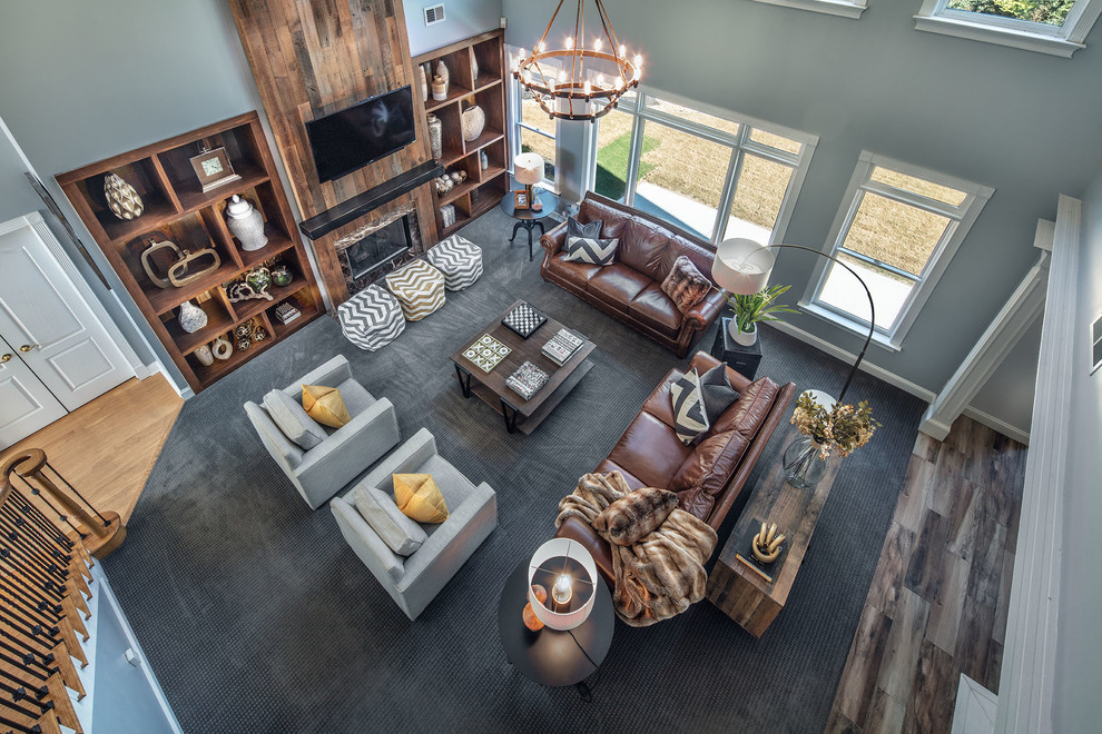 Inspiration for a large rustic open concept carpeted, gray floor and wood wall family room remodel in Atlanta with gray walls, a standard fireplace, a media wall and a stone fireplace