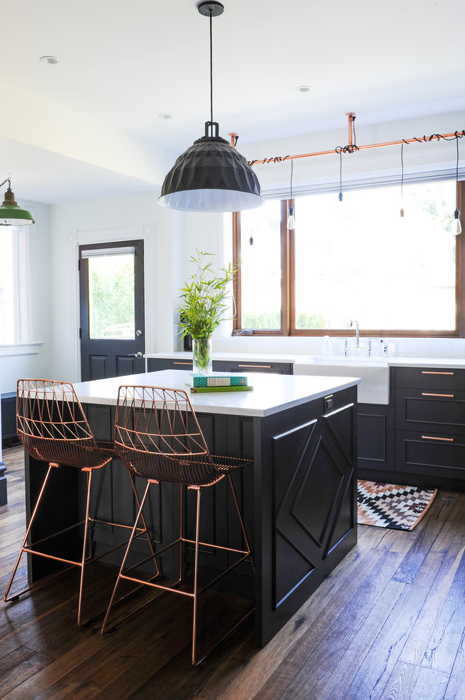 Inspiration for a mid-sized eclectic kitchen in Vancouver with a farmhouse sink, quartz benchtops, white splashback, ceramic splashback, with island, recessed-panel cabinets, dark hardwood floors and brown floor.