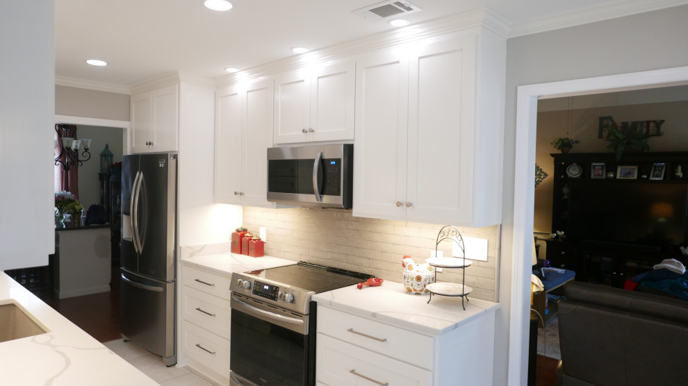 Inspiration for a mid-sized transitional galley porcelain tile and beige floor eat-in kitchen remodel with an undermount sink, shaker cabinets, white cabinets, quartz countertops, brown backsplash, porcelain backsplash, stainless steel appliances, no island and white countertops