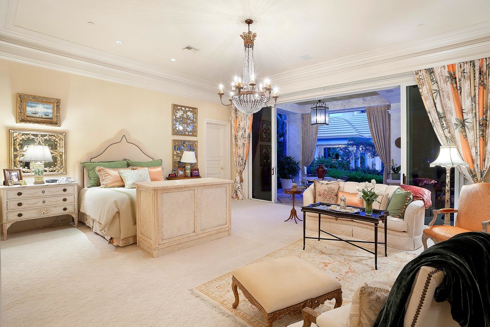 Photo of a traditional bedroom in Miami with beige walls, carpet and beige floor.
