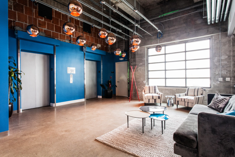 Photo of a large contemporary entryway in San Francisco with blue walls and concrete floors.