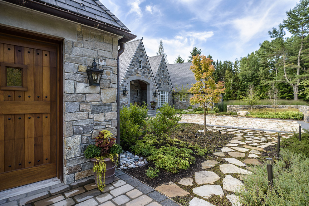 Traditional front yard garden in Burlington with natural stone pavers and a garden path for fall.