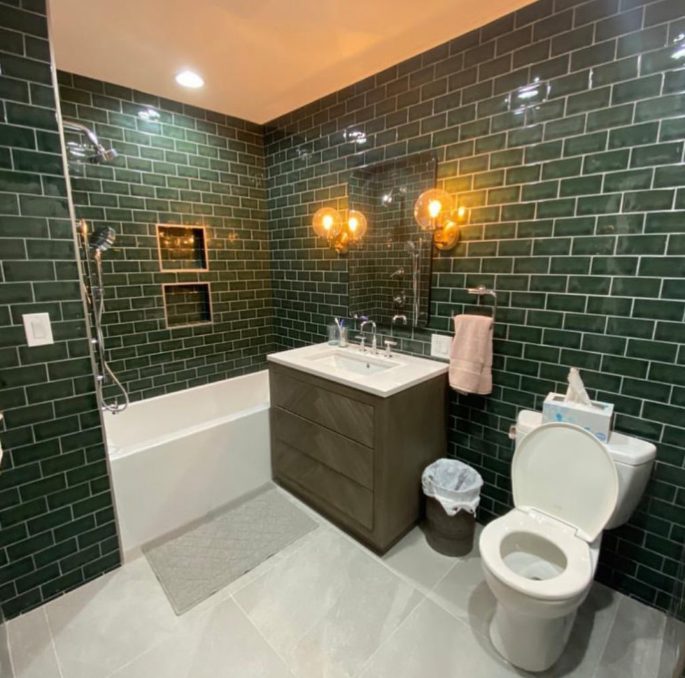 Inspiration for a large modern master bathroom in New York with flat-panel cabinets, brown cabinets, an alcove tub, a two-piece toilet, green tile, porcelain tile, green walls, porcelain floors, an undermount sink, marble benchtops, grey floor, white benchtops, a single vanity and a freestanding vanity.