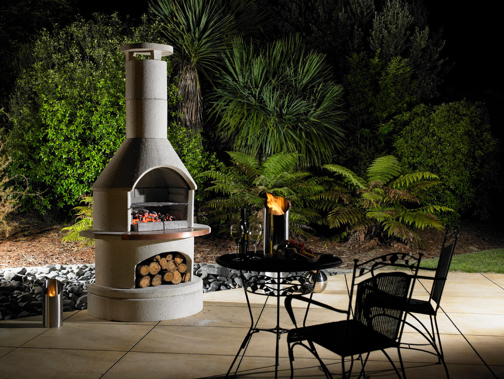 Inspiration for a mid-sized backyard patio in Brisbane with a fire feature and concrete pavers.