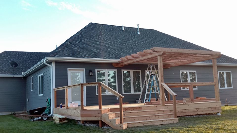 Deck - large rustic deck idea with a pergola