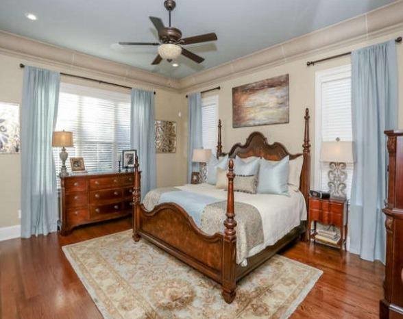Mid-sized transitional master bedroom in Atlanta with beige walls, light hardwood floors and no fireplace.