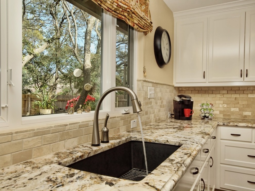 Design ideas for a transitional kitchen in Austin with a single-bowl sink, recessed-panel cabinets, yellow cabinets, granite benchtops, beige splashback and stone tile splashback.