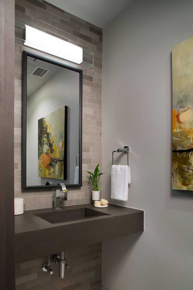 Contemporary powder room in Other with gray tile, stone tile, grey walls, concrete benchtops and an integrated sink.