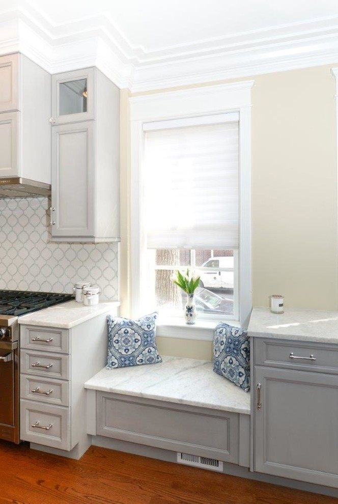 Inspiration for a mid-sized transitional l-shaped medium tone wood floor eat-in kitchen remodel in Chicago with recessed-panel cabinets, gray cabinets, multicolored backsplash, an island, quartzite countertops, mosaic tile backsplash and stainless steel appliances
