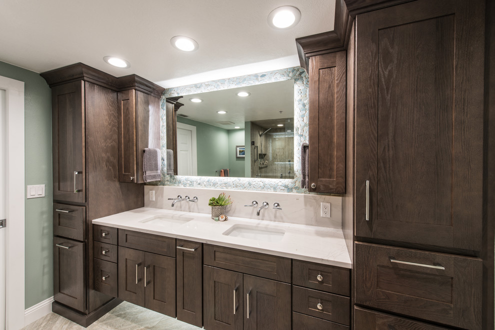 This is an example of a mid-sized contemporary master bathroom in Other with shaker cabinets, dark wood cabinets, an alcove shower, a two-piece toilet, beige tile, pebble tile, green walls, porcelain floors, an undermount sink and engineered quartz benchtops.