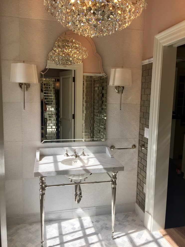This is an example of a small traditional powder room in Milwaukee with white tile, mirror tile, pink walls, marble floors, an undermount sink, marble benchtops and multi-coloured floor.